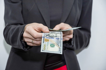 business woman holding dollars in her hands. Business concept. Many dollars in hands.