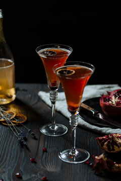 Prosecco pomegranate cocktail, garnished with dryed lemon slice
