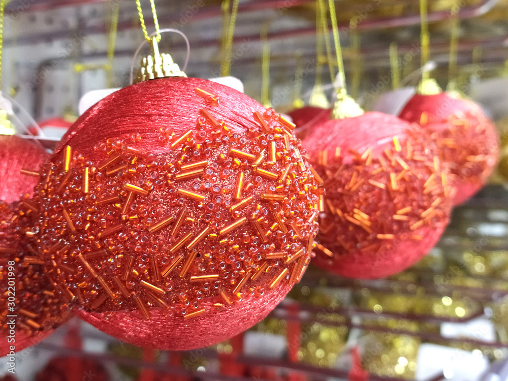 Wall mural Close-up beautiful bright red Christmas balls for the holiday on sale in the store