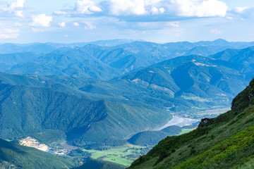 Fototapeta premium View from the summit of the beautiful mountains on a summer day.