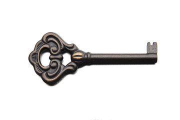 metal vintage beautiful key with twisted patterns on a light background, concept of answer, clue, close-up, copy space