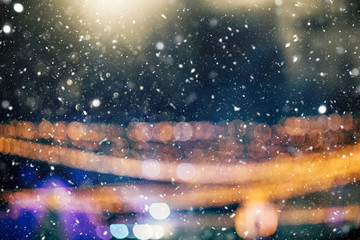 Defocused Christmas themed background with snowflakes. Christmas market theme.