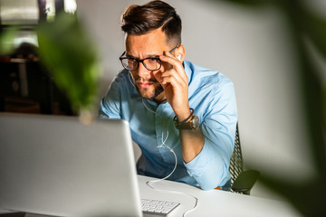 Young man sitting in his office	