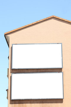 Two Empty Billboard On A Building Side Wall With Clipping Path Around The Frame And Copy Space For Your Text