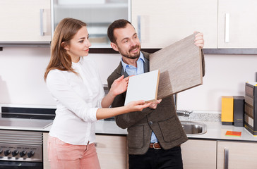 Couple choosing kitchen furniture materials