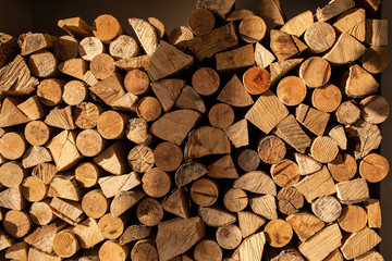 wood stump background Closeup of logs of trees outdoor on a sunny day. split wood for the fireplace, stacked. alternative, renewable energy source.