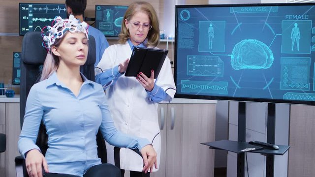Female scientis in brain activity using her tablet to