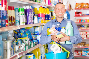 Man looking at shopping list of household detergents