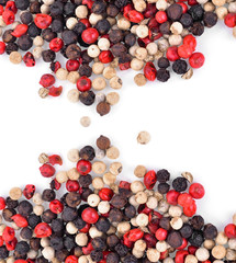 Mix from  kinds of pepper and  spoons isolated on white