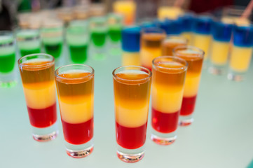 Cocktail multicolored alcohol shots at the disco
