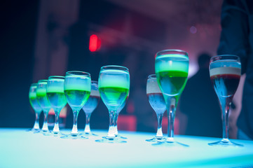 Green Alcohol Shot at a party or disco for a good mood