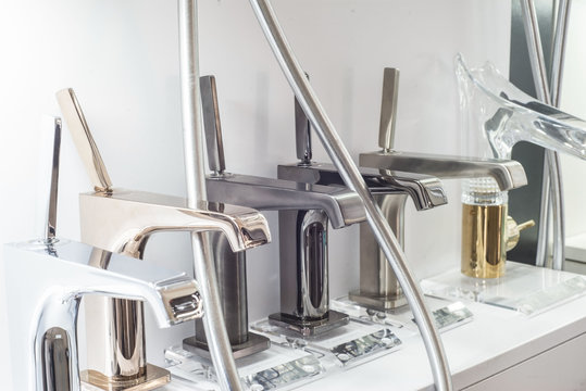 A Variety Of Faucets Taps On A White Shelf In The Store Counter