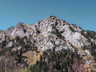 Beautiful landscape of autumn rocky Caucasus mountains among the clouds. The greatness of nature