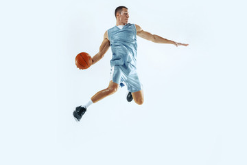 High flight. Young caucasian basketball player of team in action, motion in jump isolated on white...