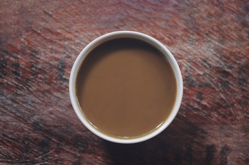 Top view of hot coffee mug brown cup on wooden table texture - Vintage effect style pictures