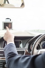 Executive using GPS navigation inside car