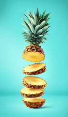 Flying fresh ripe pineapple slices - obrazy, fototapety, plakaty