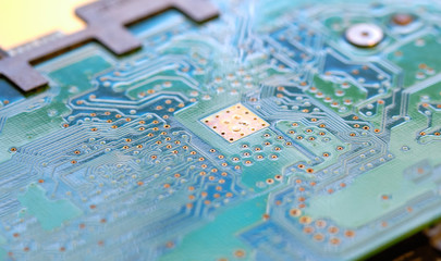 Green circuit board with microchips for electronic engineering.