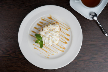 banana nut cake with cream on a white plate