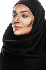 Naklejka premium young Muslim woman in hijab with facial contouring isolated on white
