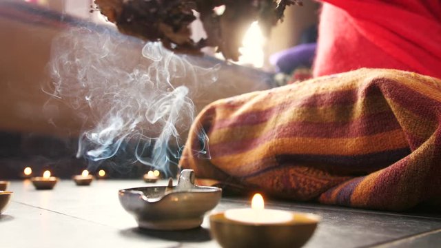 Atmospheric Midwinter ritual with candles, insence. Welness therapy to get disstressed. Close-up insence.