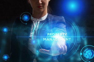 Business, Technology, Internet and network concept. Young businessman working on a virtual screen of the future and sees the inscription: Property management