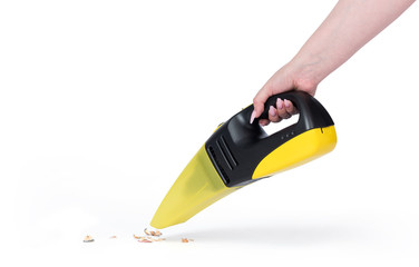 Female hand holding portable yellow vacuum cleaner, isolated on white background. File contains a path to isolation. © afxhome