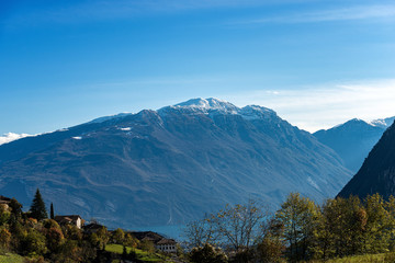 Fototapeta premium Lake Garda and Monte Baldo with snow in autumn, Italian Alps near Riva del Garda, photographed from the medieval village of Canale di Tenno, Trento province, Trentino-Alto Adige, Italy, Europe 