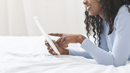 Cropped photo of afro girl using digital tablet