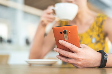 woman using cellphone at a coffee shop