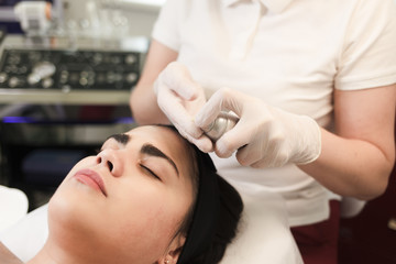 Fototapeta na wymiar Procedure for applying a moisturizing nourishing mask to the face in a beauty salon
