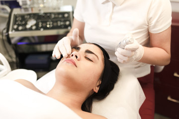 Obraz na płótnie Canvas Procedure for applying a moisturizing nourishing mask to the face in a beauty salon