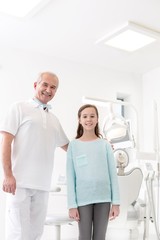 Dentist with child patient in clinic