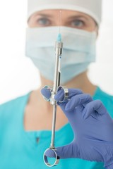Close up of surgeon holding and preparing syringe in clinic