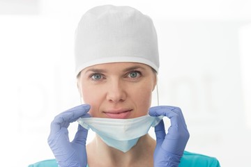 Close up surgeon wearing mask and cap in clinic
