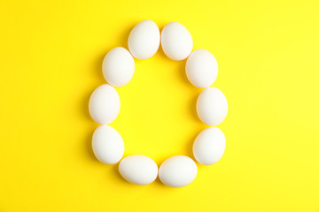 Flat lay composition with chicken eggs on color  background, space for text