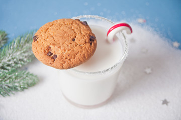 Glass of milk, homemade cookies for Santa on the white background