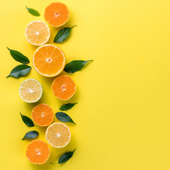 Creative background with tropical fruits. Orange, lemon, lime, grapefruit on a yellow background. Flat lay top view copy space. Nutrition Concept, Vitamin C, Disease Prevention, Flu