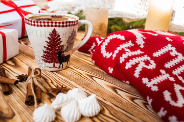 Christmas mug of hot cocoa on wooden background. Christmas mood in detail.