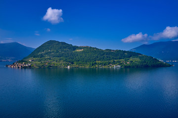 Coastline, Lake Iseo surrounded by mountains, Monte Isola island, Italy. Aerial view