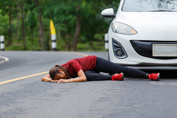Woman runner has a car crash between running training at public road.