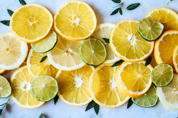 Orange, lemon and lime slices on a marble board