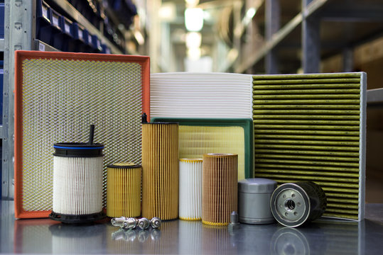 Oil filter, air filter, cabin filter, fuel filter, spark plugs, engine oil. Auto parts close up.