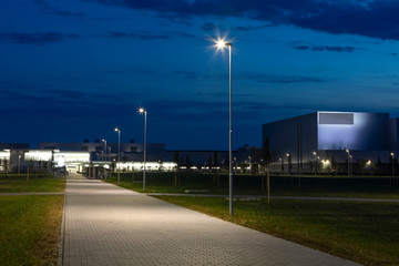 night empty walkway into modern industrial zone, with modern LED street light