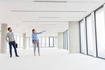 Fototapeta premium Business people discussing and looking at new office interior