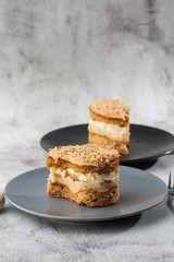 Banana or nut cake on gray plate on marble background. Selective focus. Vertical photo. Menu for bakery. cafe menu. Pastry. Delicious and sweet dessert at cafe restaurant.