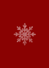 White snowflake on red background. Happy New Year and merry Christmas. Postcard for the holiday.