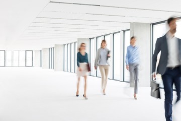 Business people walking in office hall