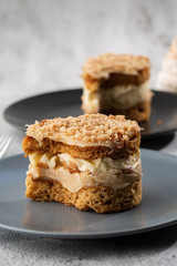 Banana or nut cake on gray plate on marble background. Selective focus. Vertical photo. Menu for bakery. cafe menu. Pastry. Delicious and sweet dessert at cafe restaurant.