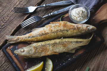 Fried fish with sauce and lemon